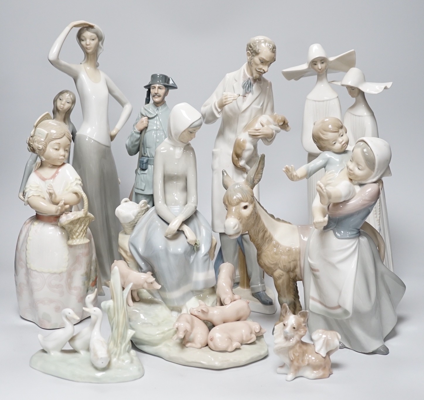 A collection of nine Lladro porcelain figures, tallest 36cm